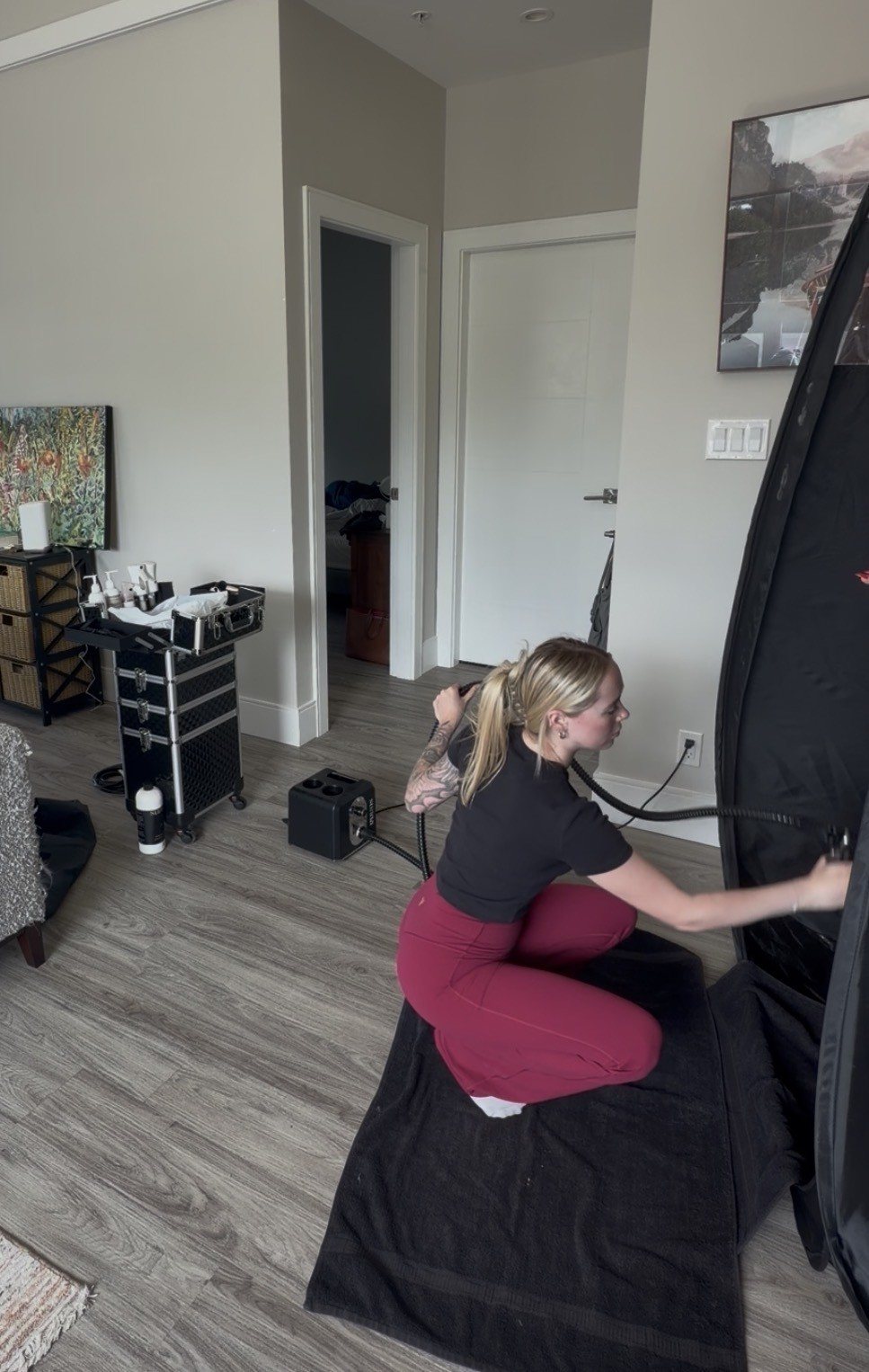 Mobile spray tan kit and tent set up in a client's living room in Nanaimo